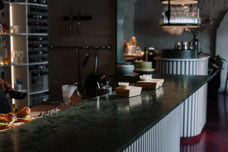 Closer to the Kitchen, Closer to the Truth: Why the Bar Counter Beats the Table Every Time